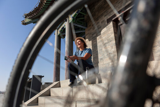 Woman with bicycle near ancient city wall in Xi'an
