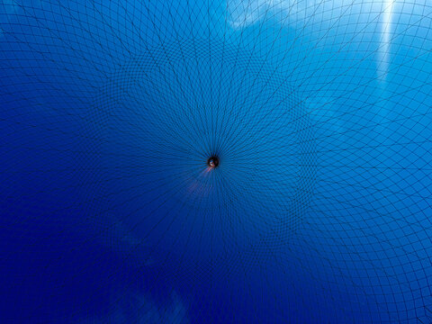 Radial net pattern against vibrant blue sky background