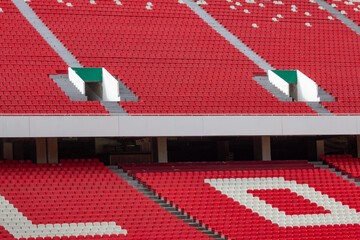 Empty red stadium seats anticipating big football events © GABRIEL
