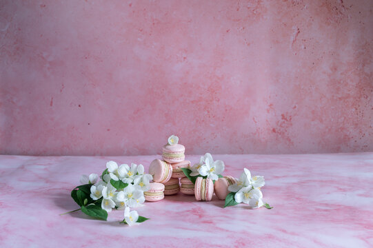 Pink macarons with pistachio cream and spring flowers