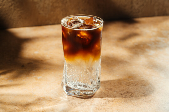 Iced espresso tonic in a glass with ice cubes