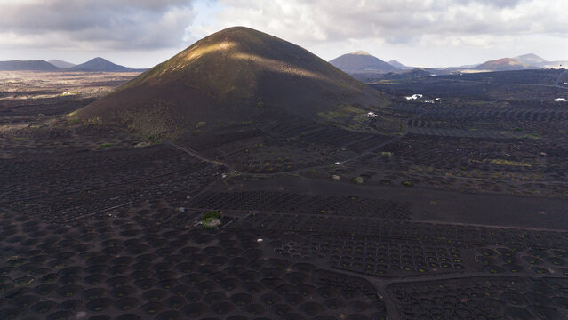 Magical light over Lanzarote volcano and grape fields