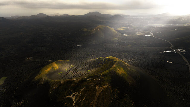 Magical light over Lanzarote volcanic vineyard landscape