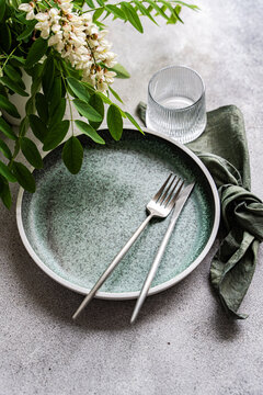 Rustic table setting with acacia flower and glass