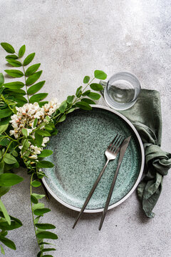 Rustic table setting with acacia flower greenery
