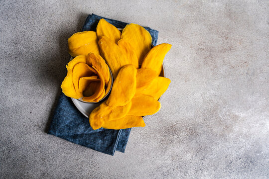 Sliced dried mango on a ceramic plate