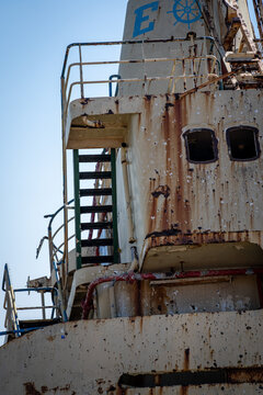 View of the weathered and rusty superstructure of the Edro III shipwreck with metal stairs and railings under a clear blue sky in Paphos, Paphos, Cyprus.
