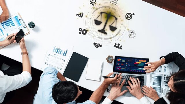 A dynamic business team engages in data analysis while exploring themes of justice and fairness. Laptops, charts, and collaboration drive decision-making in a modern office setting. Raster