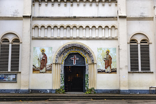 Douala, Cameroon - 28 April 2025: View of the decorated entrance of the Cathedral of Saints Peter and Paul with religious icons and floral arrangements in Douala, Cameroon.
