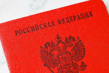 A red Russian passport sitting on a table, great for travel or cultural themed projects © Fotograf