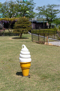 Plastic soft serve ice cream cone decoration in the grass, Japan