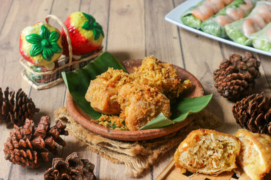 Crispy tahu isi, a popular Indonesian street snack, is made by stuffing fried tofu with vermicelli and julienned carrot, coating it in batter, and frying it to golden perfection.