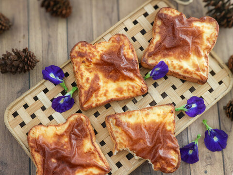 Freshly baked Basque burnt cheese toast, made from white bread and cream cheese, with a glossy, golden‑brown surface.