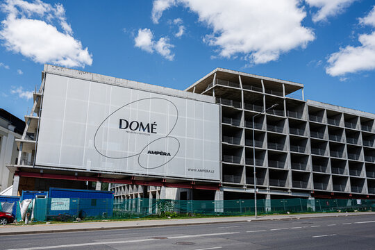 Partially constructed concrete building with large billboard on urban Ampera construction site in Vilnius, Lithuania showing development and modern architecture