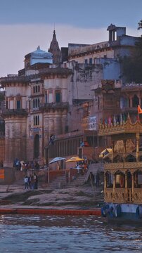 Varanasi, India. Many Boats Moored On Ganga River Near Lassi Ghat And Tulsi Ghat. Gold Beautiful, Richly Decorated Pleasure Boat For River Ride. Family Holiday In India. Evening At Sacred Varanasi