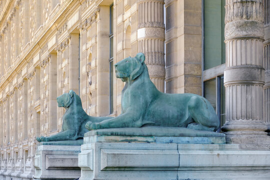 Lion Sculpture in Front of a Stone Building