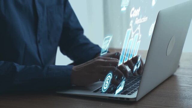 Hands typing on laptop with digital financial graphics overlay, representing modern technology, data analysis, and investment strategies in a business environment. Qubit.