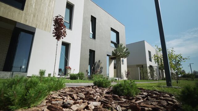 Newly built modern residential townhouses in a suburban neighborhood on a bright sunny day