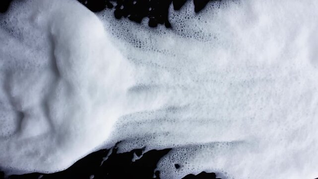 White foam covering dark liquid surface