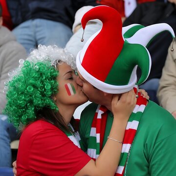 Woman in red shirt wearing green christmas elf hat