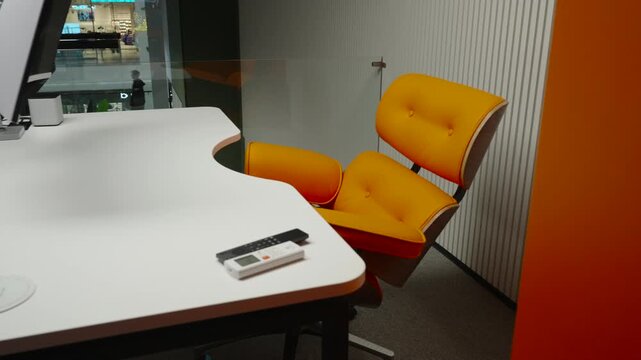 Modern empty office workspace with desk, monitor, and yellow chair