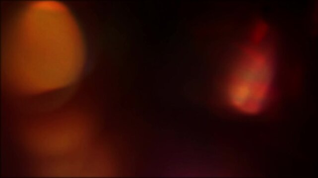 Defocused Multicolored Lens Flare Studio Light Leak Overlay with Organic Amber Orange Bokeh Orbs, Rainbow Prism Edge and Dark Cinematic Glow