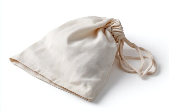 Small beige textile drawstring gift bag or pouch on white background with drawstring, packaging