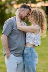 Fototapeta premium couple of man and woman hugging in the summer in a city park