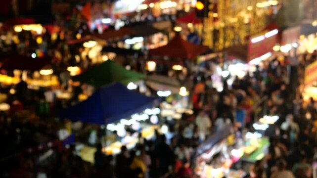 Crowd of Asians at night market. Phra Samut Chedi Temple fair. It is one of the biggest temple fairs in Thailand. People can easily get there by BTS city train from Bangkok. 