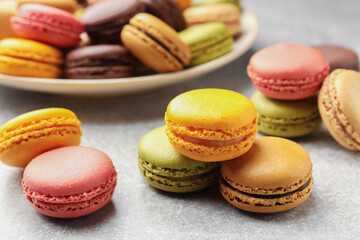 Fototapeta premium Yummy colorful macarons on light grey table, closeup