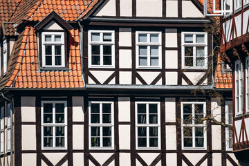 Naklejka premium Half-timbered houses with white windows and red tiled roofs in the historic old town of Hanover