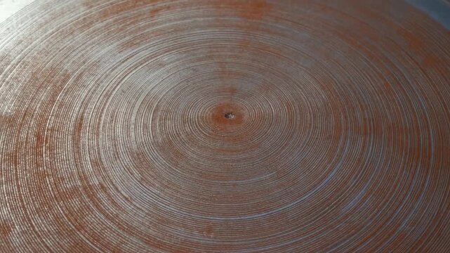Rusted circular metal surface with concentric grooves