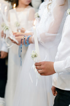 Communion. Children hold candles at a ceremony during a special event in a community center
