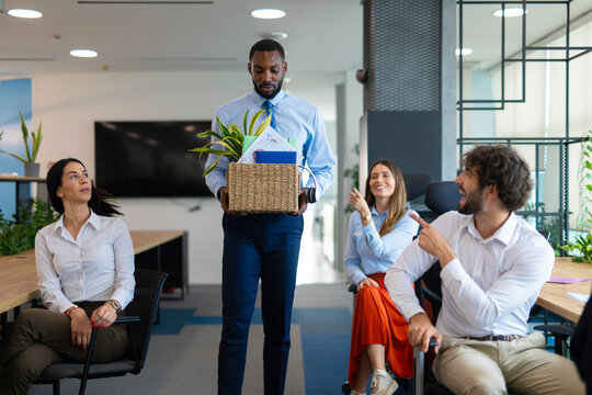 Employee leaving office after job termination carrying belongings