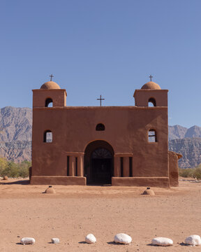 Traditional adobe church with two bell towers and domes in the desert, Catamarca, Argentina