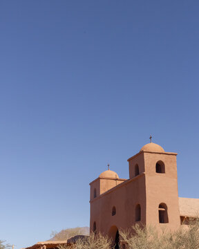 Traditional adobe church with two bell towers and domes in the desert, Catamarca, Argentina