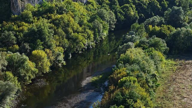 Aerial view of small boat navigating scenic Iskar River canyon near Prohodna Cave, Bulgaria