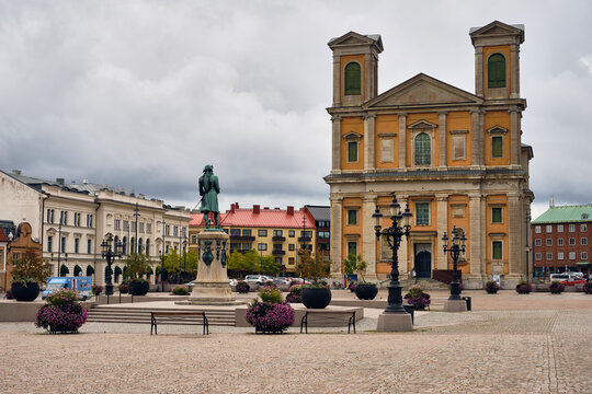 Karlskrona, Sweden - 14 September 2025: View of Fredrikskyrkan church and the statue of King Karl XI at Stortorget square under a cloudy sky.