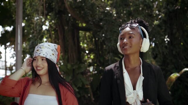 Young women friends enjoying bubbles in a park