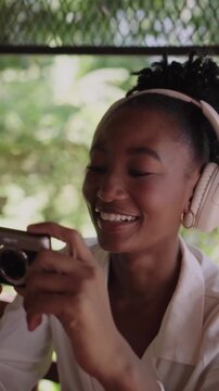 Joyful young photographer laughing while taking pictures