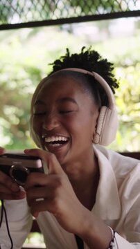 Young woman listening to music and taking pictures