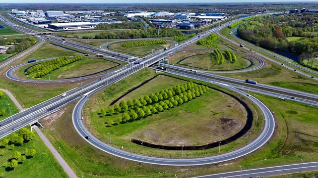 Aerial drone view road junction. Clover roundabout view from above. Car traffic on autobahn Netherlands. High quality 4k footage