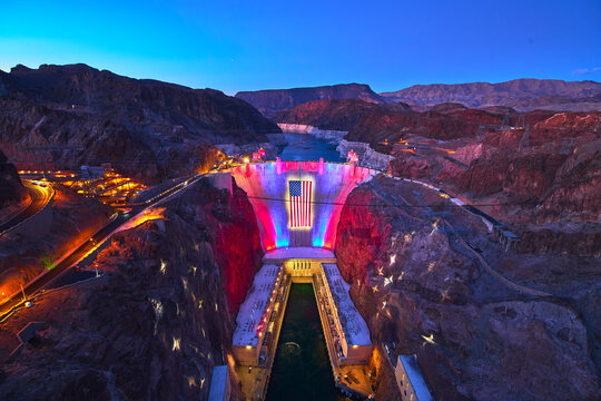 Hoover Dam Nevada Lit With American Flag and Red White Blue Lights at Night