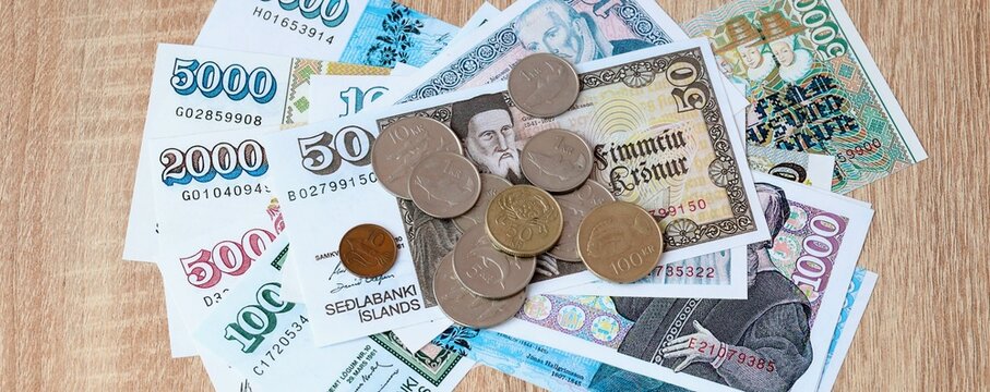 Icelandic krona money bills and coins on table. Iceland cash of ISK currency close up