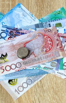 Kazakhstani tenge money bills and coins on table. Kazakhstan cash of KZT currency