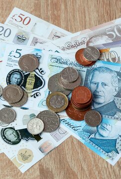 British pound money bills and coins on table. United Kingdom cash of GBP currency close up