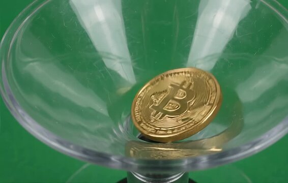 Golden Bitcoin Coin Spinning Inside Clear Funnel on Green Background