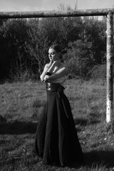 Fototapeta premium young woman in a black dress. summer nature. black and white portrait