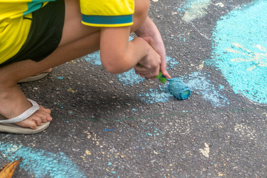 Rio de Janeiro, Brazil - 13 June 2026: View of a person painting the asphalt with a blue roller as part of street decorations for the World Cup 2026.
