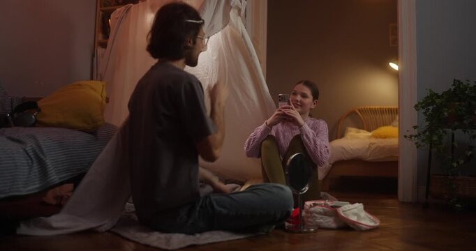 Teen girl applying makeup in cozy bedroom hideout